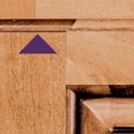 Close-up of a cabinet corner showing natural color variation between the frame and panel.